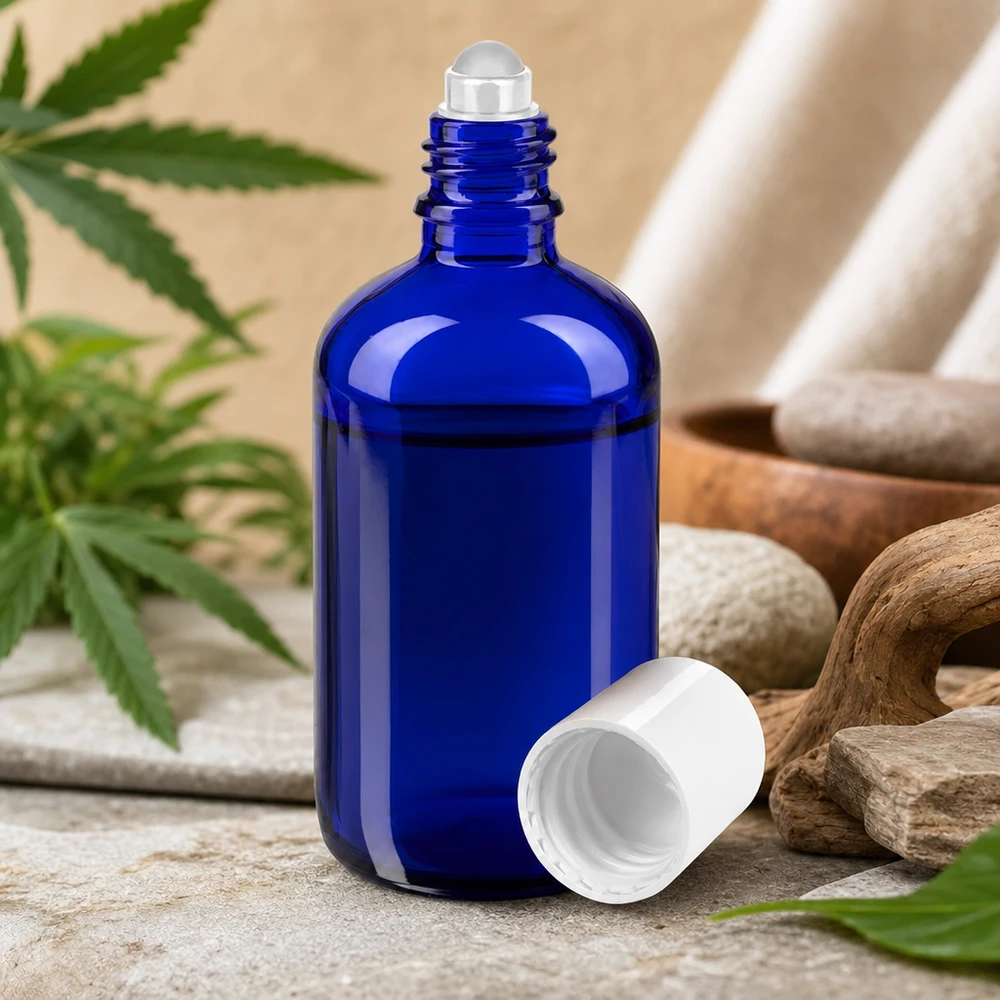 Flacone roll-on blu da 100ml STD bianco ApoGlas Flacone roll-on in vetro da farmacia blu da 100 ml con pietre naturali e foglie di cannabis